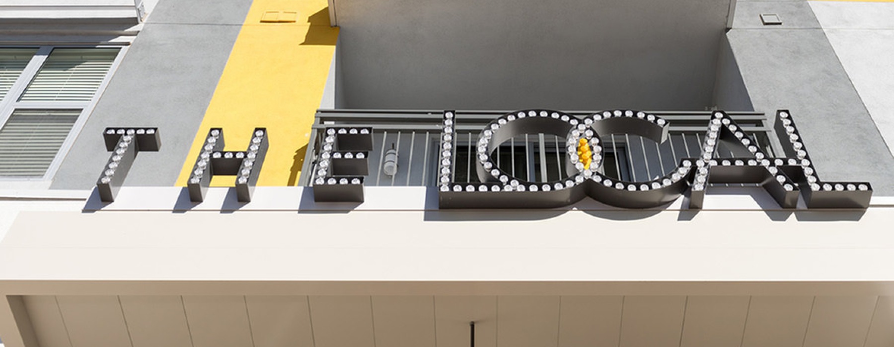 an upward view of a building with a sign