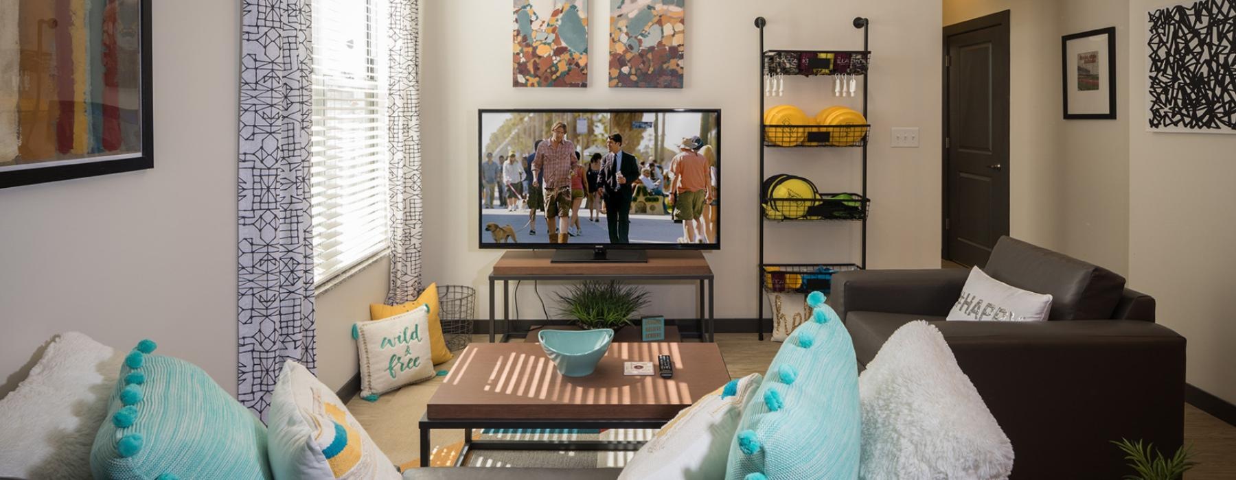 a living room with a tv and couches