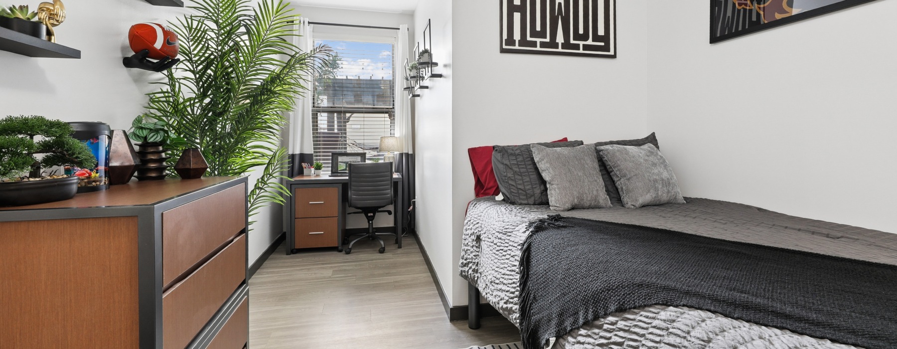 a bedroom with a bed, desk and chair